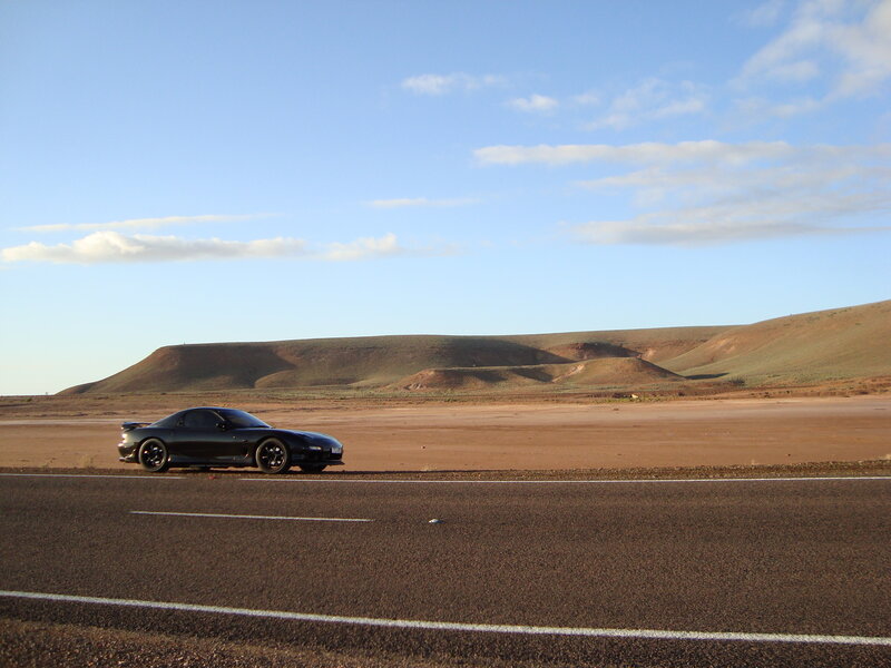 Black sports car on desert road