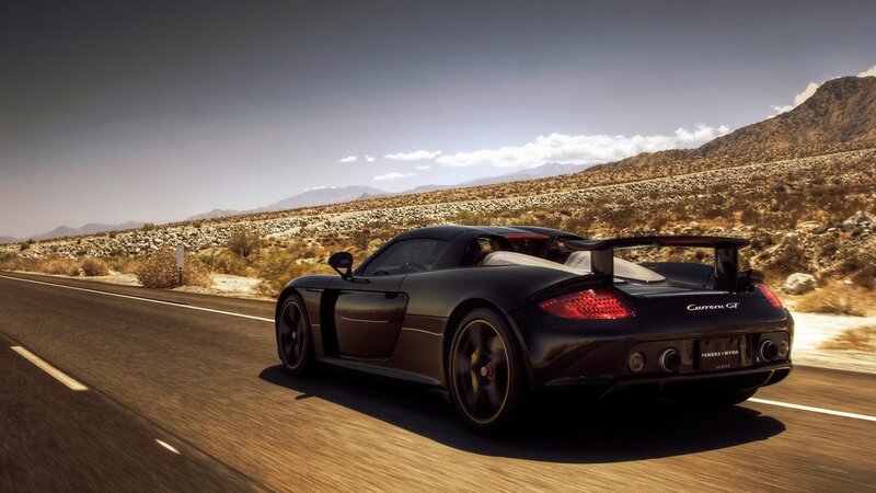 Black sports car on desert road