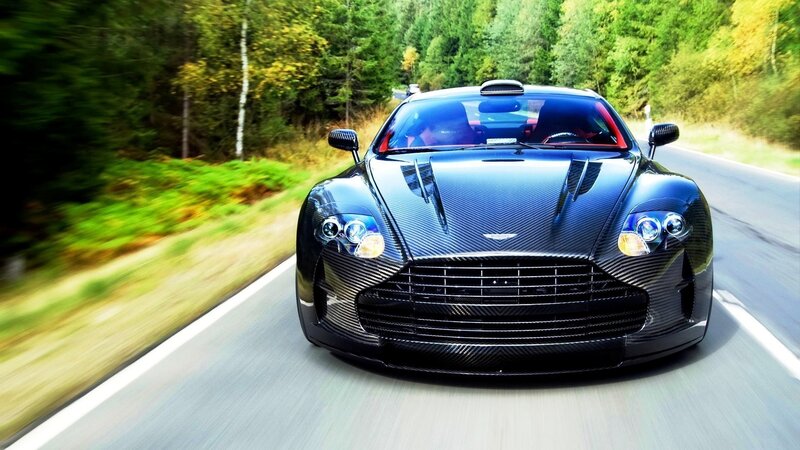 Black sports car on forest road