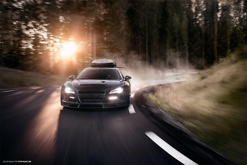 Black sports car on forest road