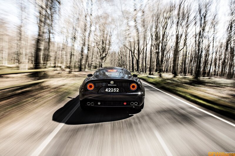 Black sports car on forest road