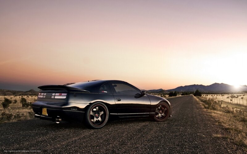 Black sports car on gravel road