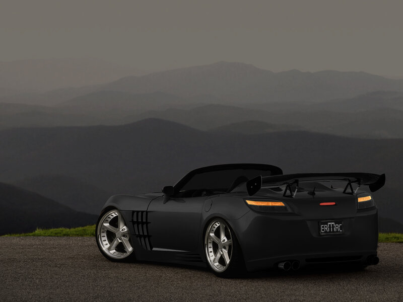 Black sports car on mountain road