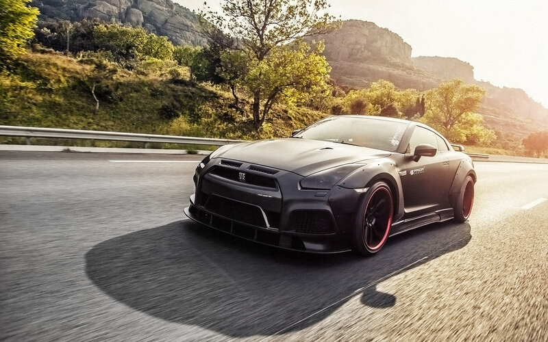 Black sports car on mountain road