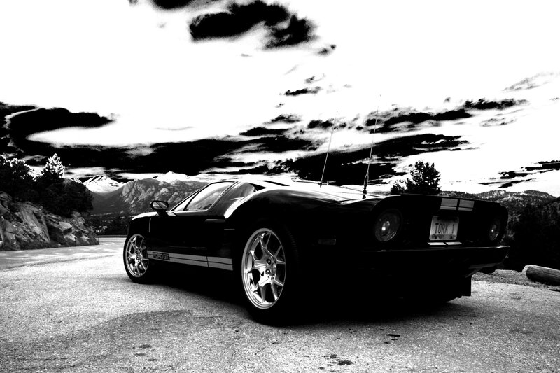 Black sports car on mountain road