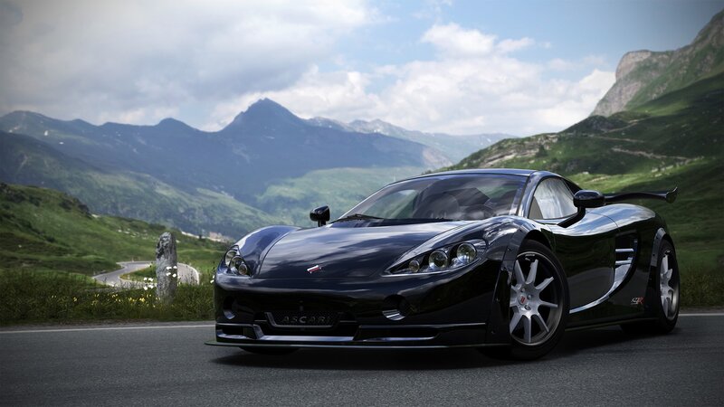 Black sports car on mountain road