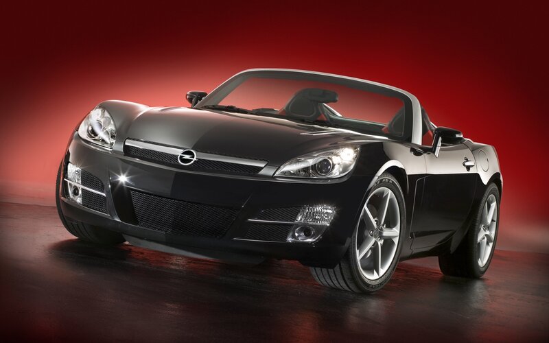 Black sports car on red background