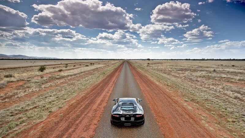 Black Sports Car on Road — Blue, Dramatic