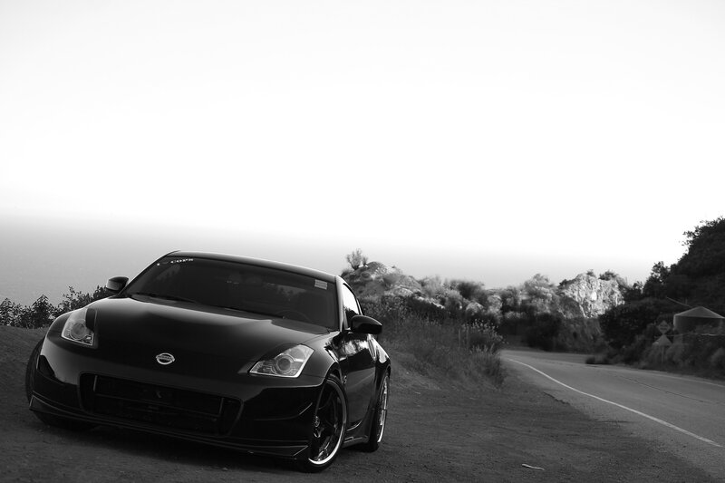 Black Sports Car on Road — Dramatic, Sunset, Photograph, Hills