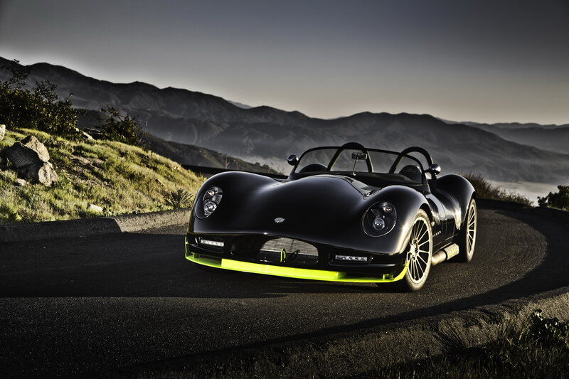 Black Sports Car on Road — Dramatic, Sunset, Photograph, Mountains, Grass