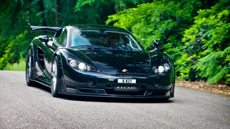 Black Sports Car on Road — Dynamic, Afternoon, Photograph, Driver