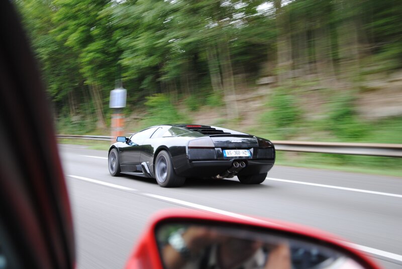 Black Sports Car on Road — Dynamic, Afternoon, Photograph, Trees, Side Mirror