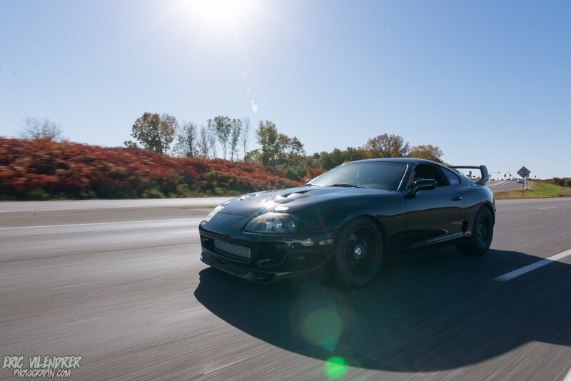 Black Sports Car on Road — Dynamic, Afternoon, Photograph, Trees, Sun