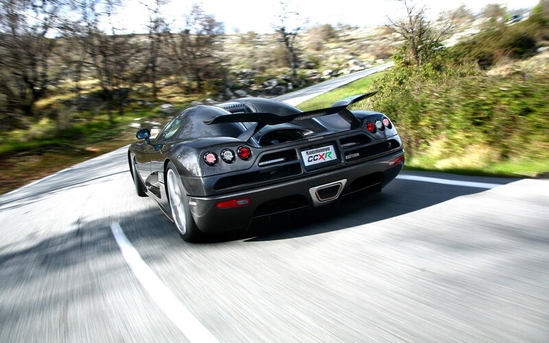 Black Sports Car on Road — Dynamic