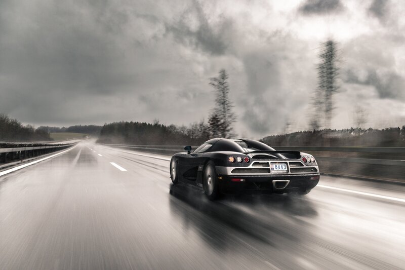 Black Sports Car on Road — Gray, Dramatic, Photograph