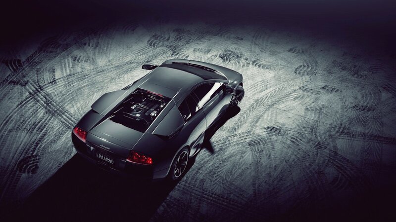black sports car on tire tracks