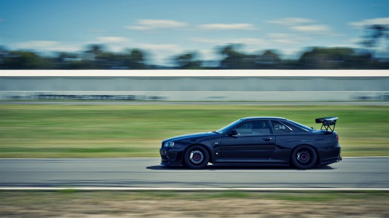 Black Sports Car on Track — Dynamic, Afternoon, Photograph, Race Track, Grass, Sky, Green, Blue, C26