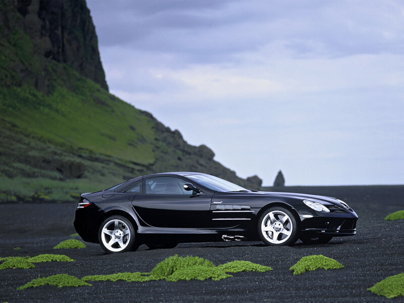 Black sports car on volcanic beach