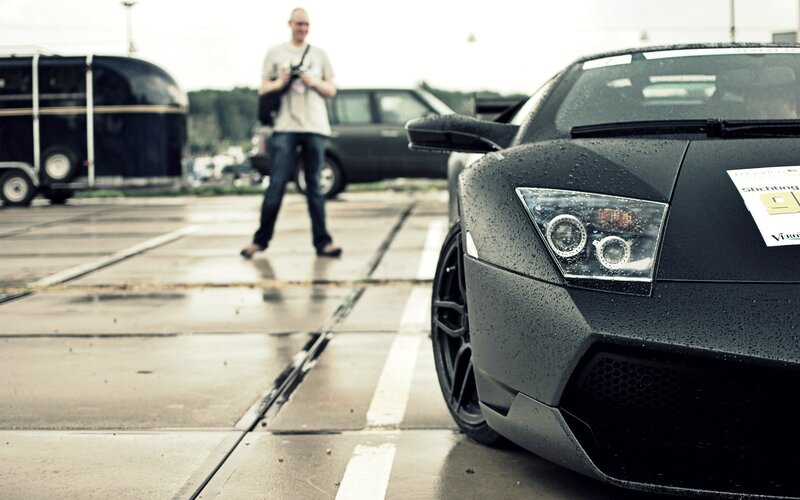 Black sports car on wet pavement