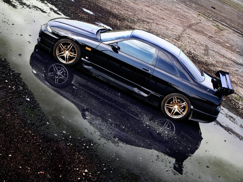 Black sports car on wet pavement