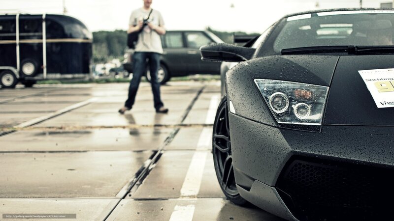 Black sports car on wet pavement