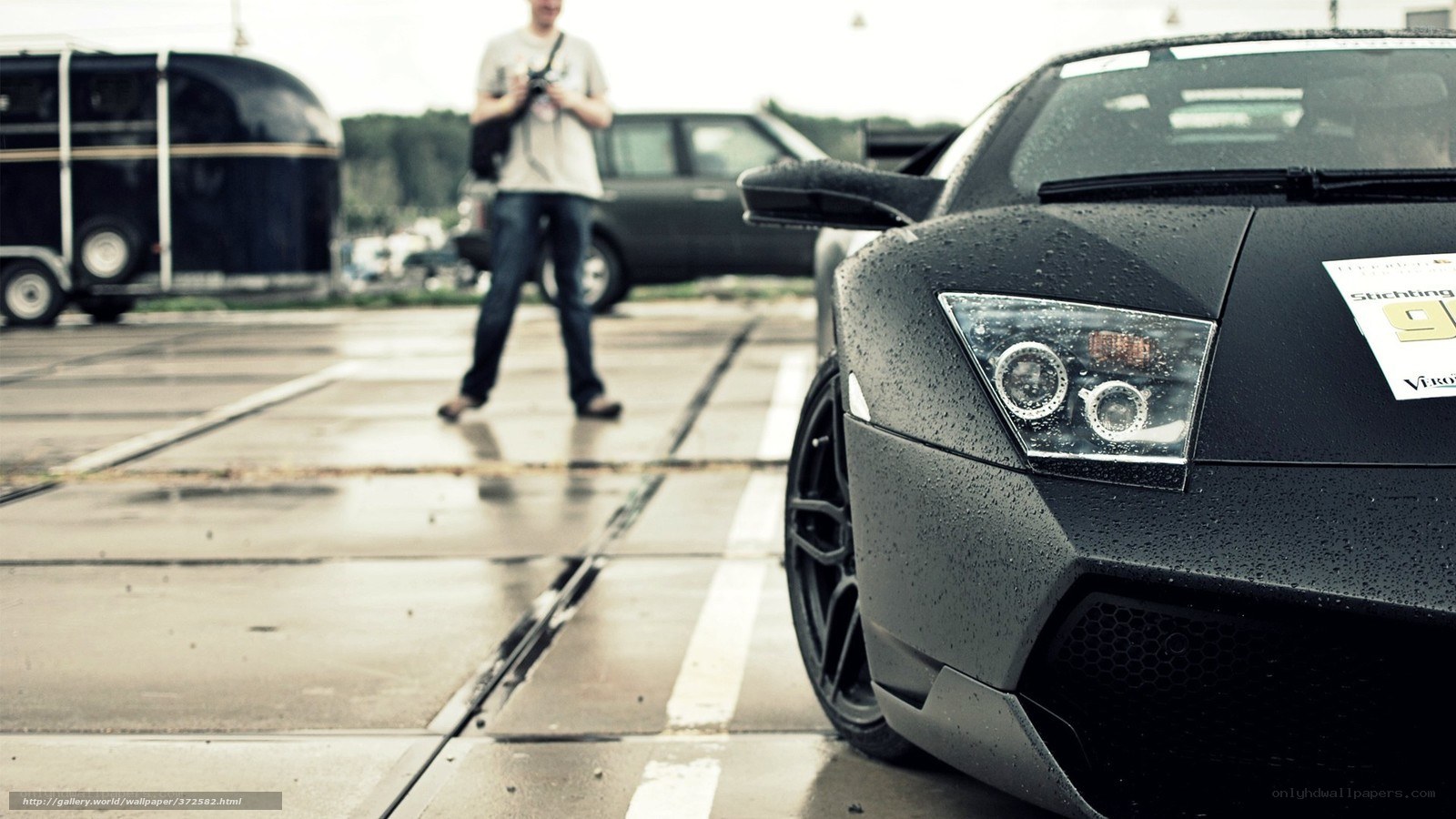 Black sports car on wet pavement