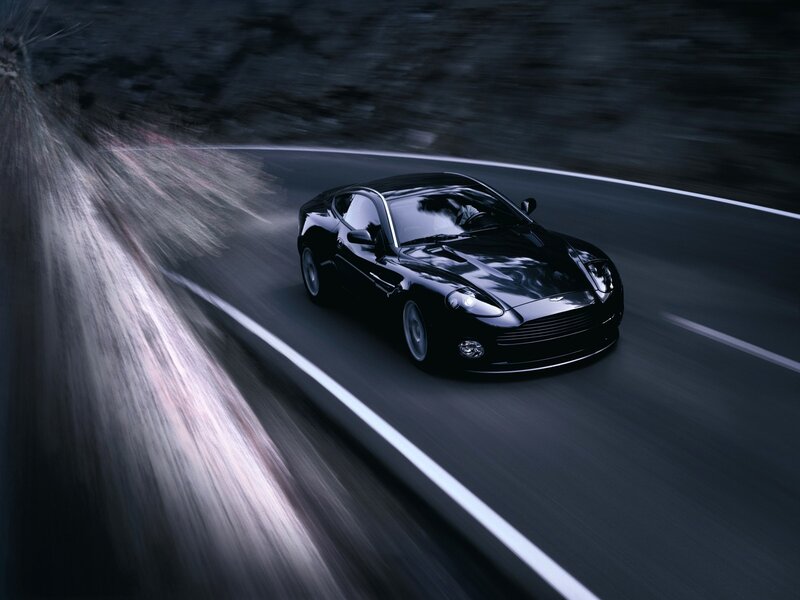 Black sports car on winding road
