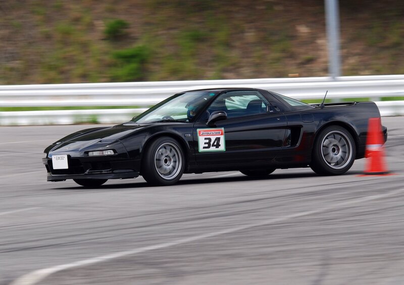 Black sports car racing on track