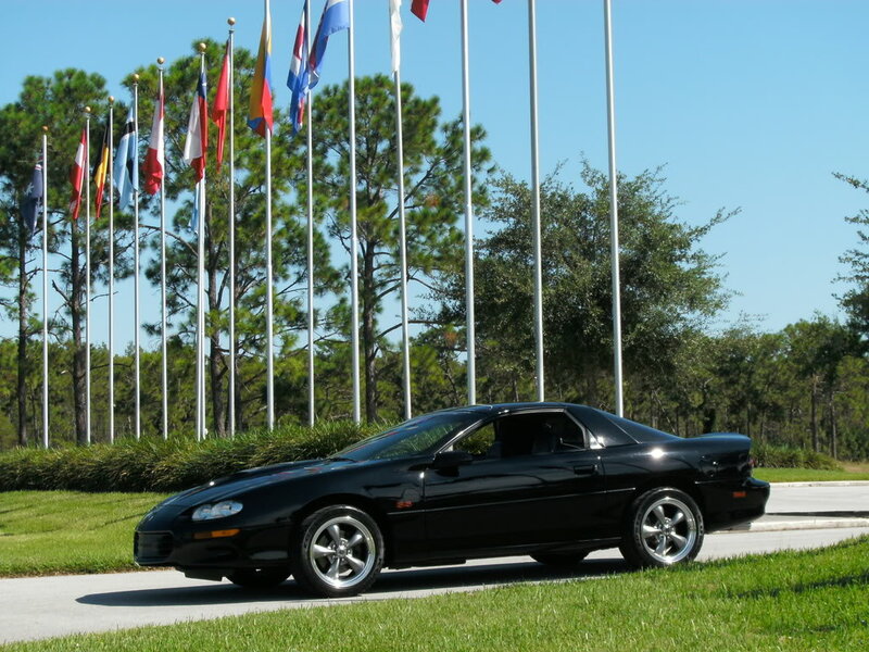 Black Sports Car — Serene, Afternoon, Photograph, Flags