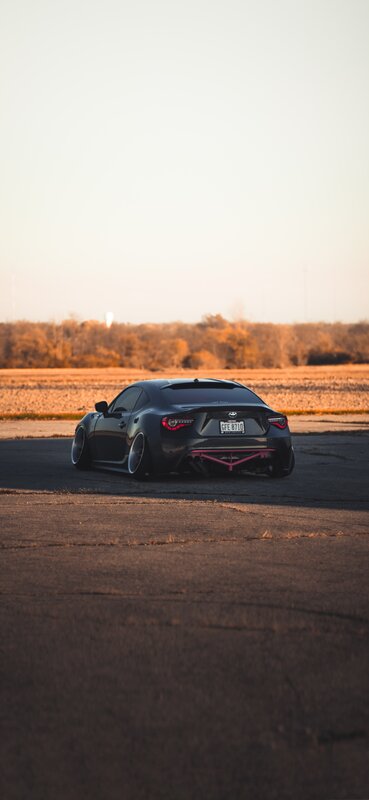 Black Sports Car — Serene, Sunset, Photograph, Field