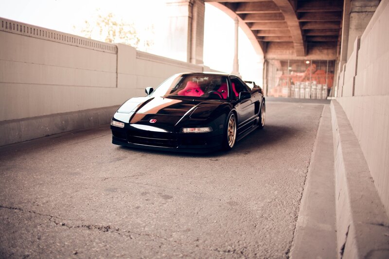 Black sports car under bridge