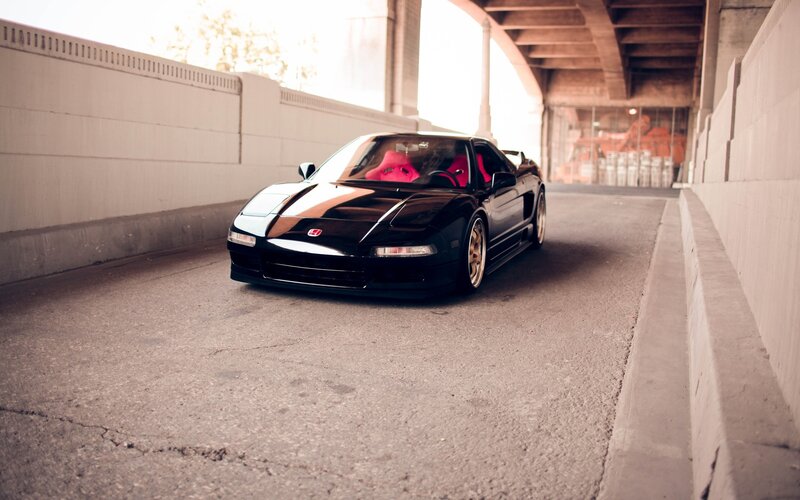 Black sports car under bridge