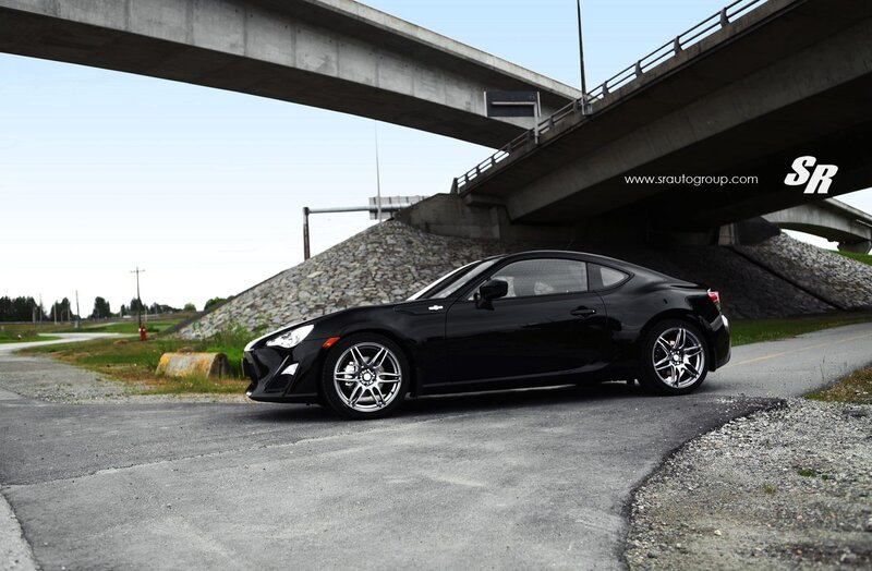 Black sports car under bridge