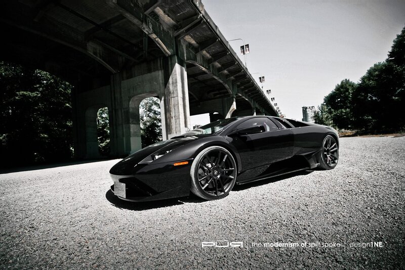 Black sports car under bridge