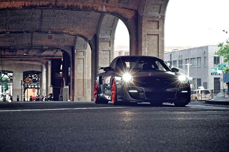 Black sports car under bridge