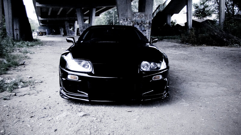 Black sports car under bridge