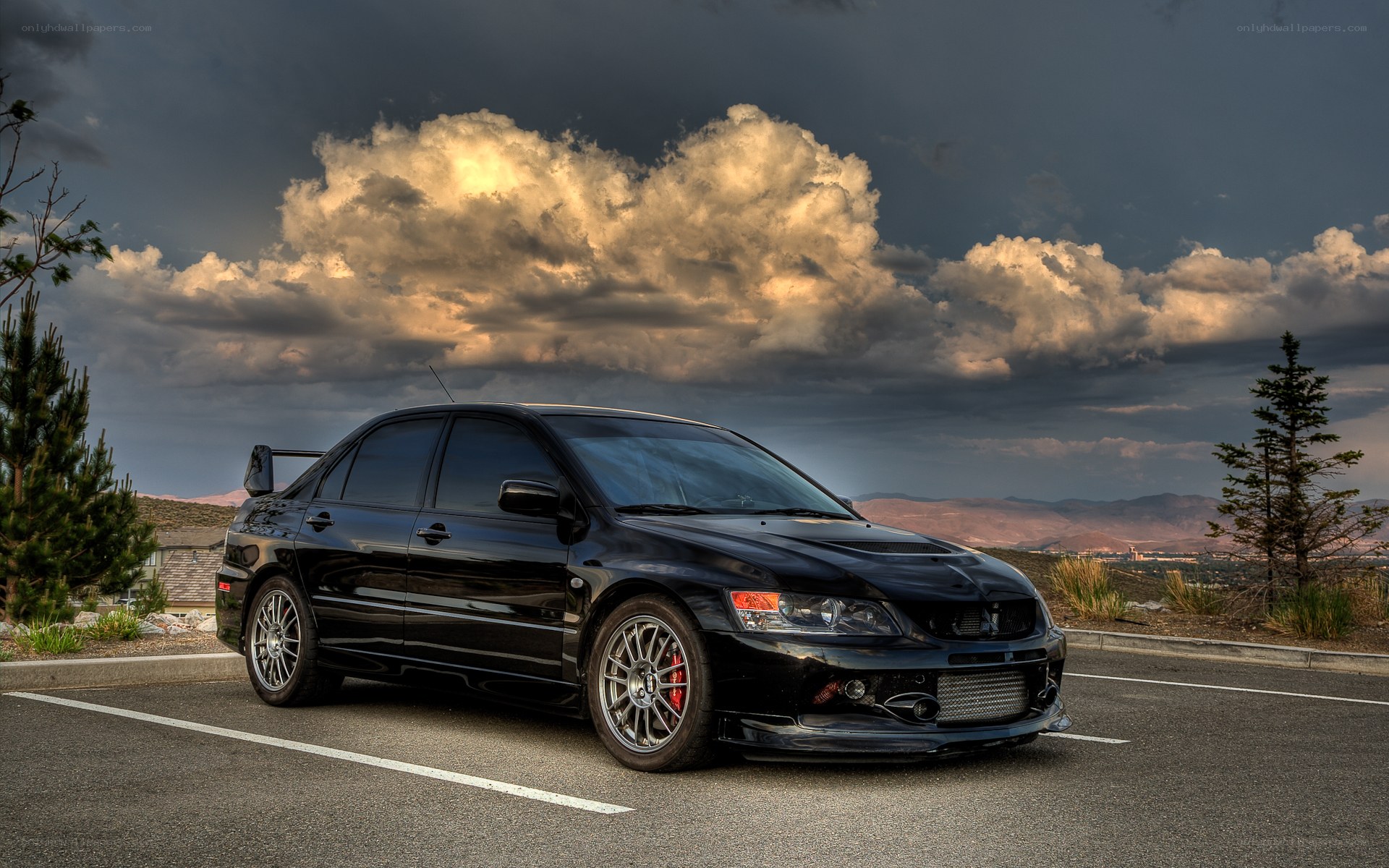 Black sports car under dramatic sky