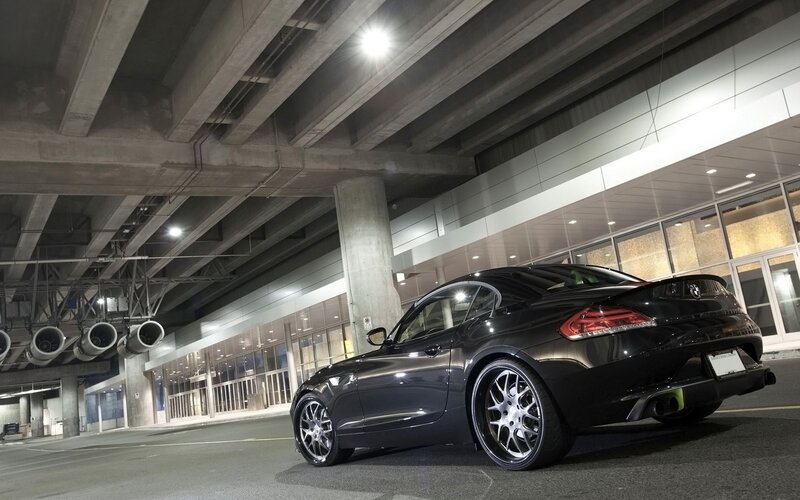 Black sports car under overpass