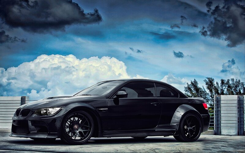 black sports car under stormy sky