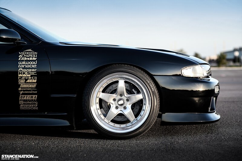 black sports car with custom wheels