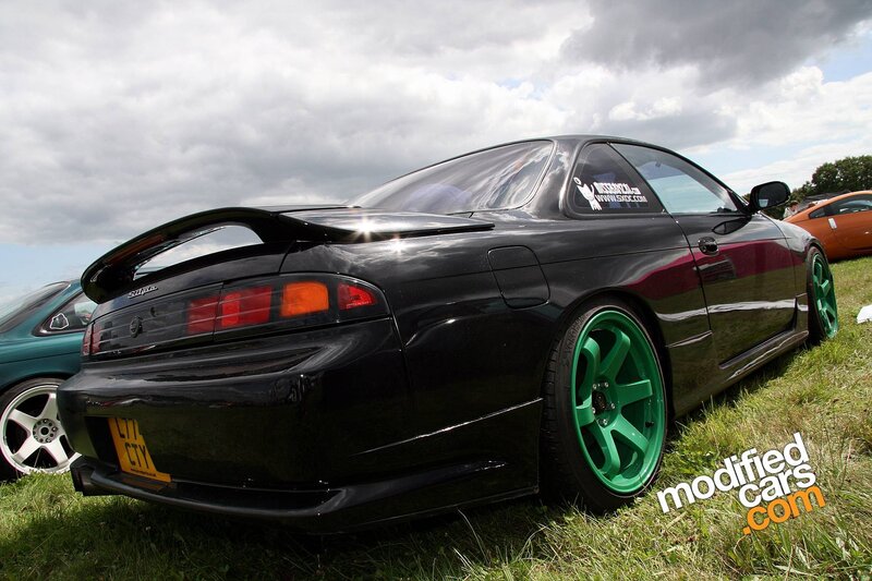 black sports car with green wheels