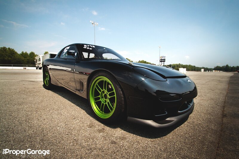 black sports car with green wheels