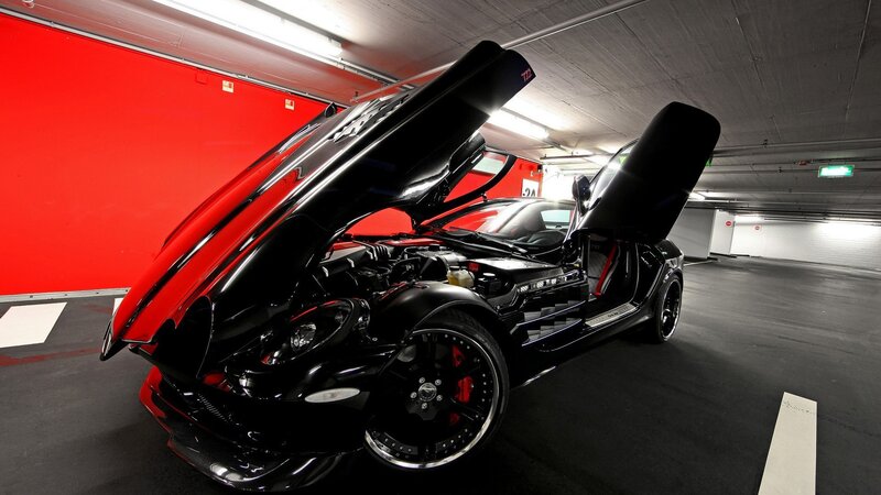 Black sports car with open doors