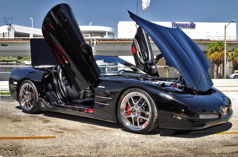 Black sports car with open doors