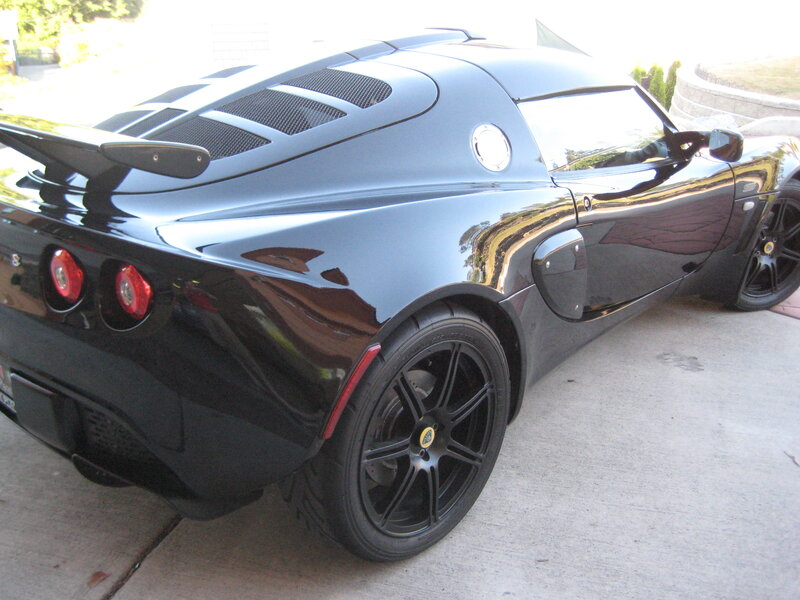 black sports car with rear spoiler