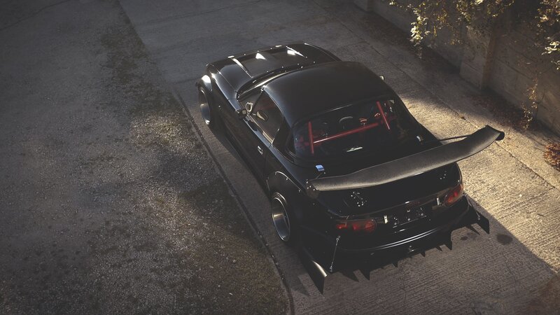 black sports car with rear wing