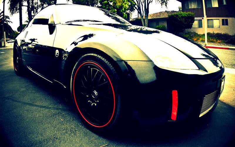 Black sports car with red rims