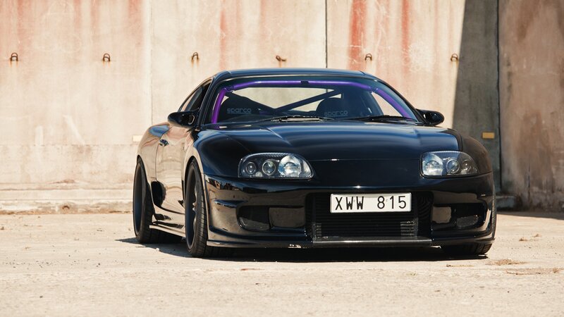 black sports car with roll cage