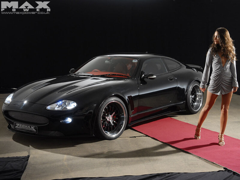Black sports car with woman on red carpet