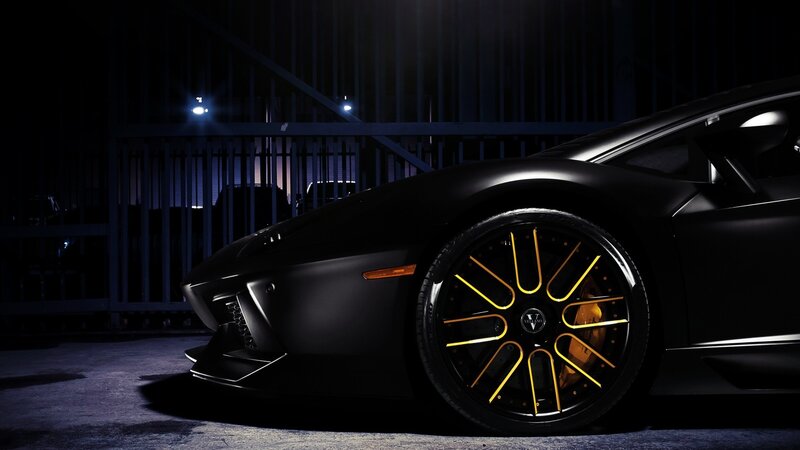 black sports car with yellow wheels